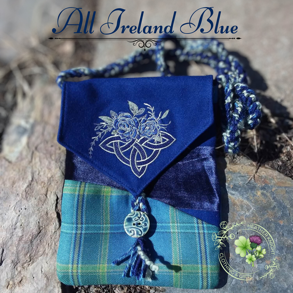 Blue fabric pouch with floral embroidery on a stone surface, featuring 'All Ireland Blue' text.