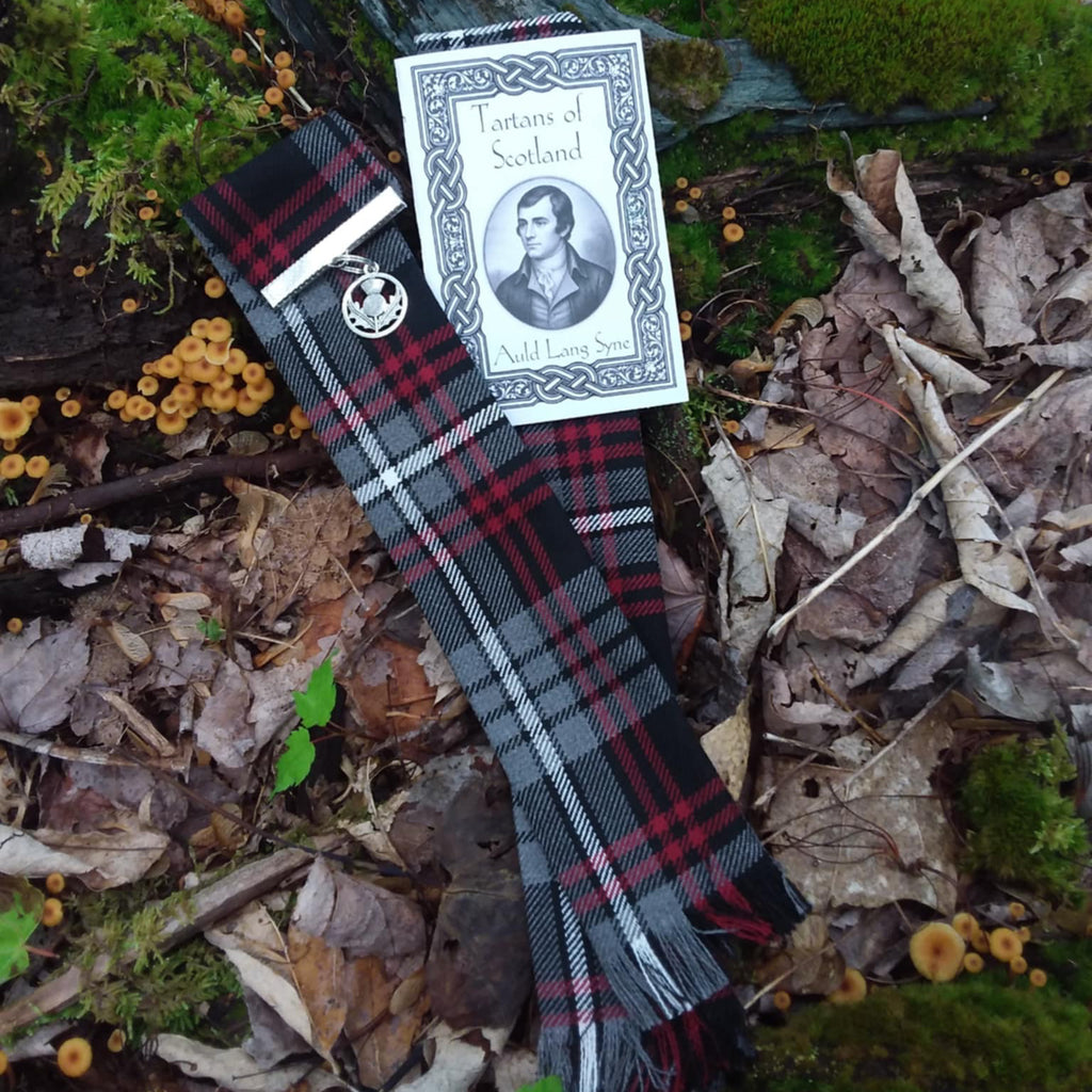 Auld Lang Syne Tartan Bookmark with a tag on a forest floor