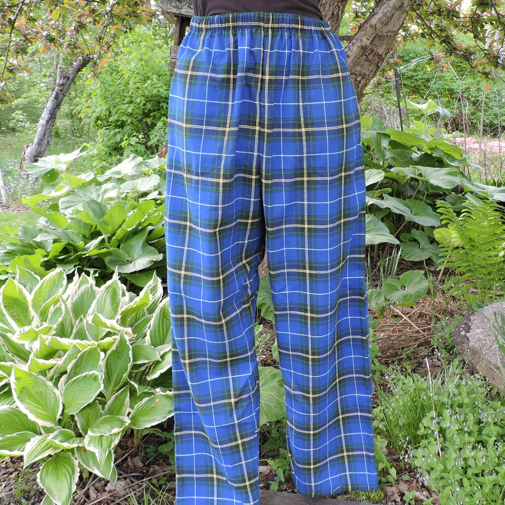 Person wearing Nova Scotia tartan pants standing in a garden