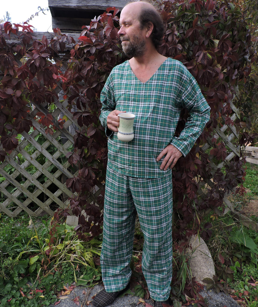 A person standing outdoors wearing a Cape Breton Tartan  pyjama set with a v-neck and shirttail hem.